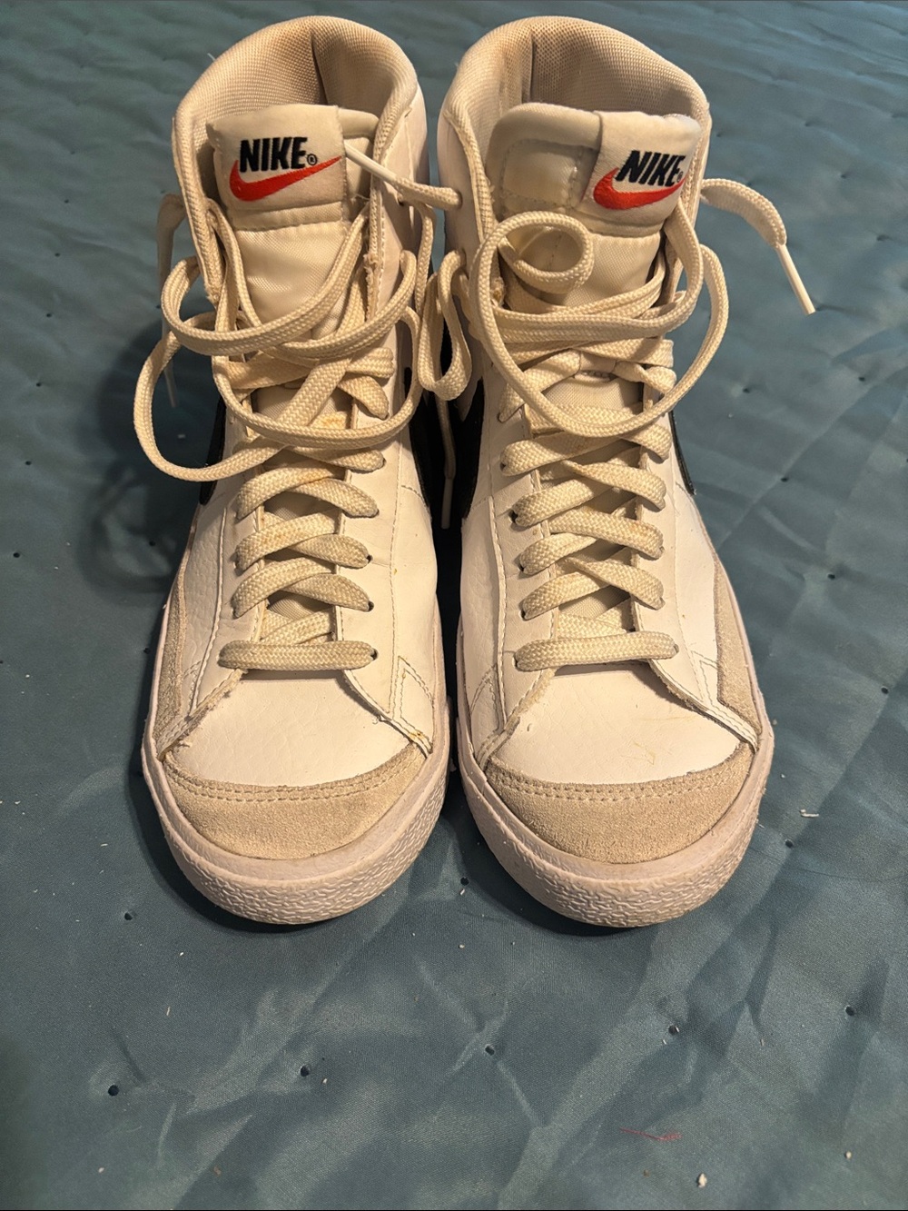 Nike White High-Top Sneakers with Black Swoosh